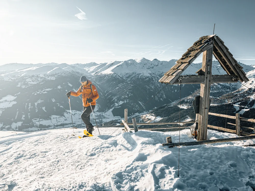 GRETI in Bad Hofgastein: dein alpines Boutique Hotel Skifahrer neben einer hölzernen Konstruktion auf einem verschneiten Berggipfel